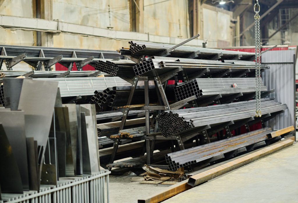 Horizontal image of stack of ready metal products lying on pallet in warehouse for shipping